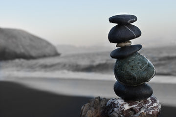 Stack of stones on a beach, balancing out to represent a healthy life styles