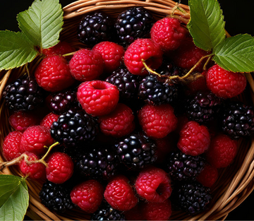 Basket of fresh natural raspberries, blackberries, strawberries, cherries with fresh leaves 